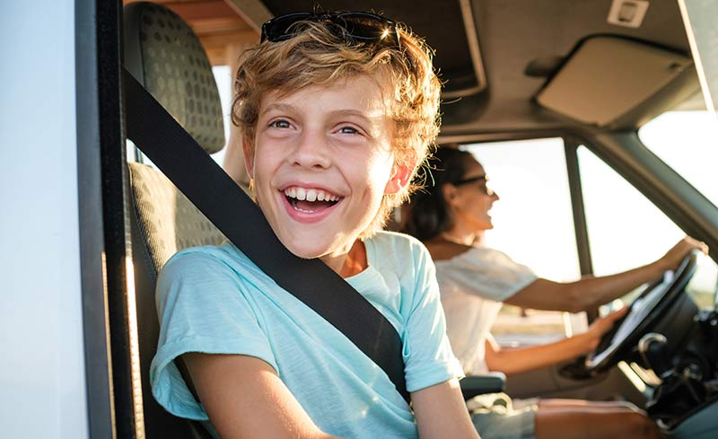 boy rides in front seat of RV