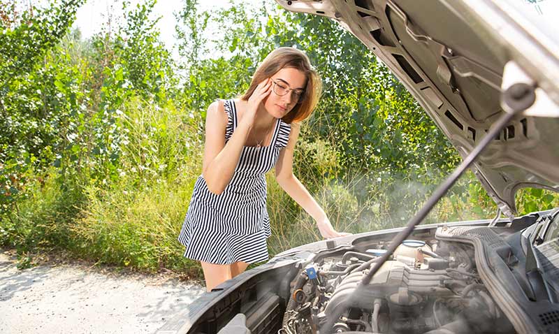 woman stresses over car engine