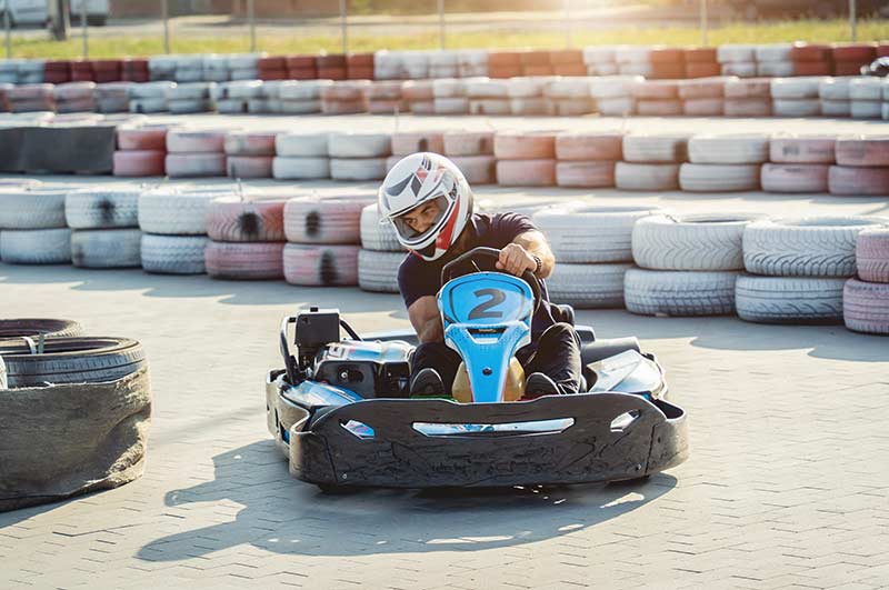 go kart driver leans into turn