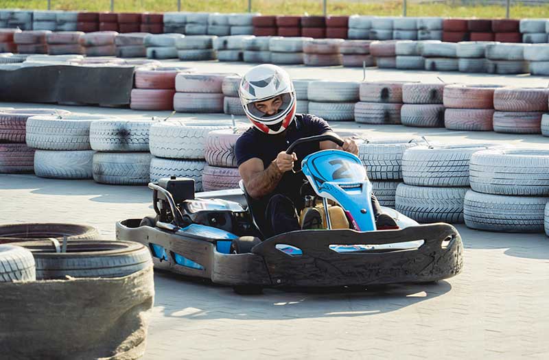 driver takes tight turn in go kart
